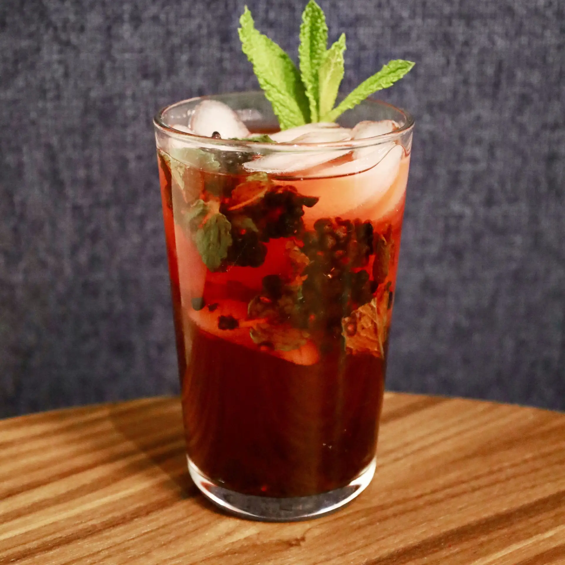 Drinks XXL Blackberry Mojito cocktail with mint and ice in a tall glass.